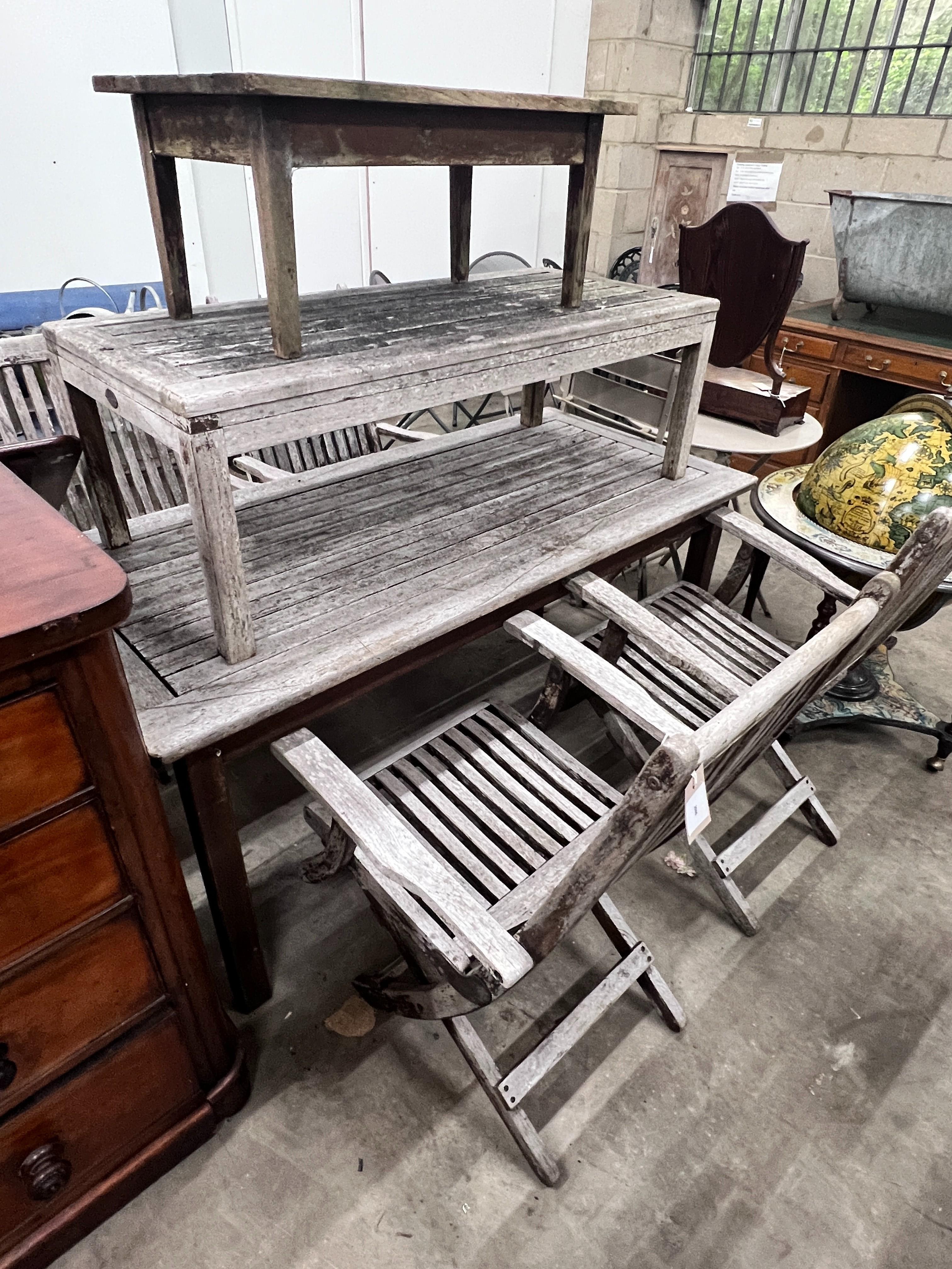 Four Westminster teak folding garden elbow chairs, Indian Ocean weathered teak rectangular garden table, length 151cm, depth 70cm, height 73cm and two low tables